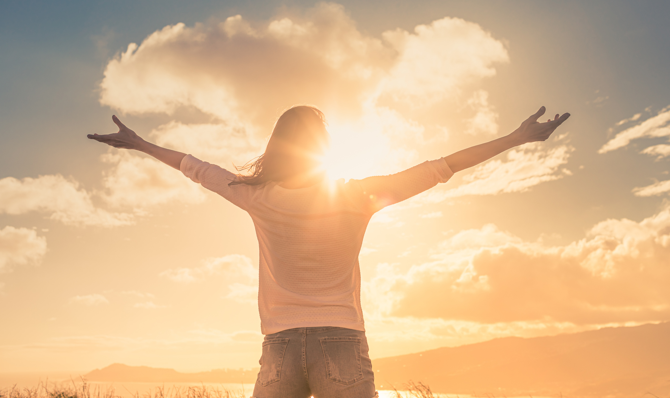 Person standing with arms open toward the sun, symbolizing healing, growth, and hope through individual counselling in Coquitlam and online with Trueself Counselling